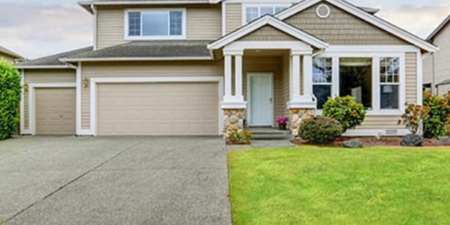 Beige two-story house with driveway.