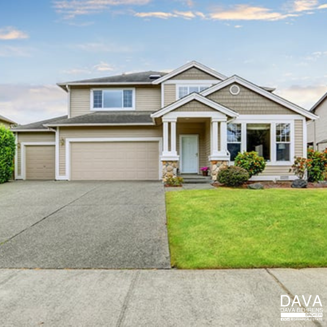 Beige two-story house with driveway.