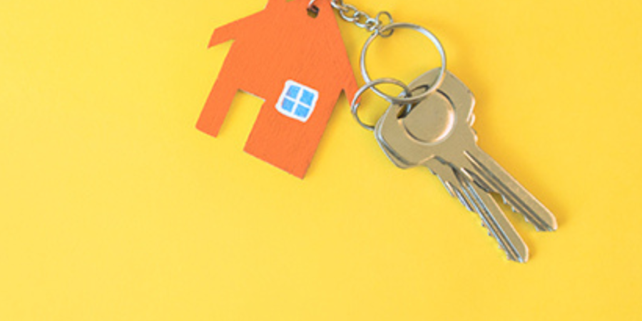 House-shaped keychain with keys.