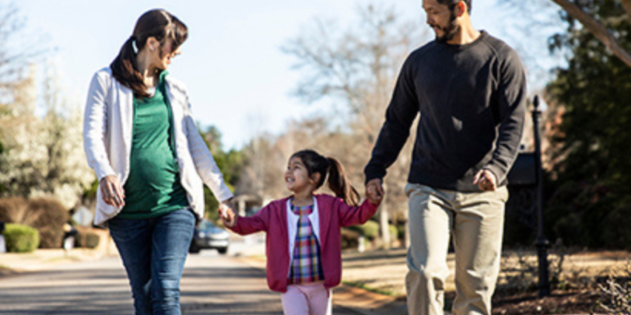 Happy family walking down the street.