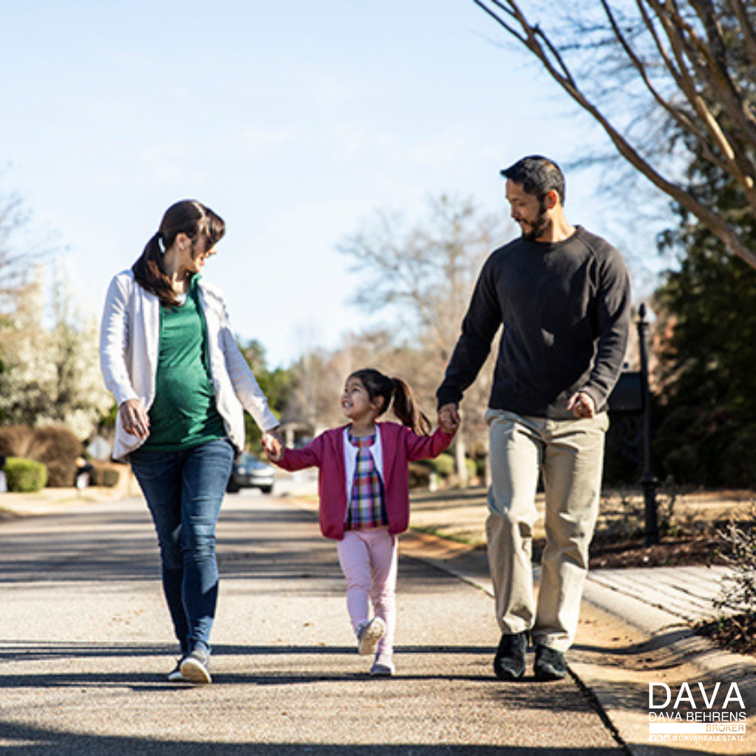 Happy family walking down the street.