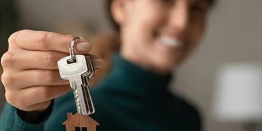 Woman holding house keys, new home.