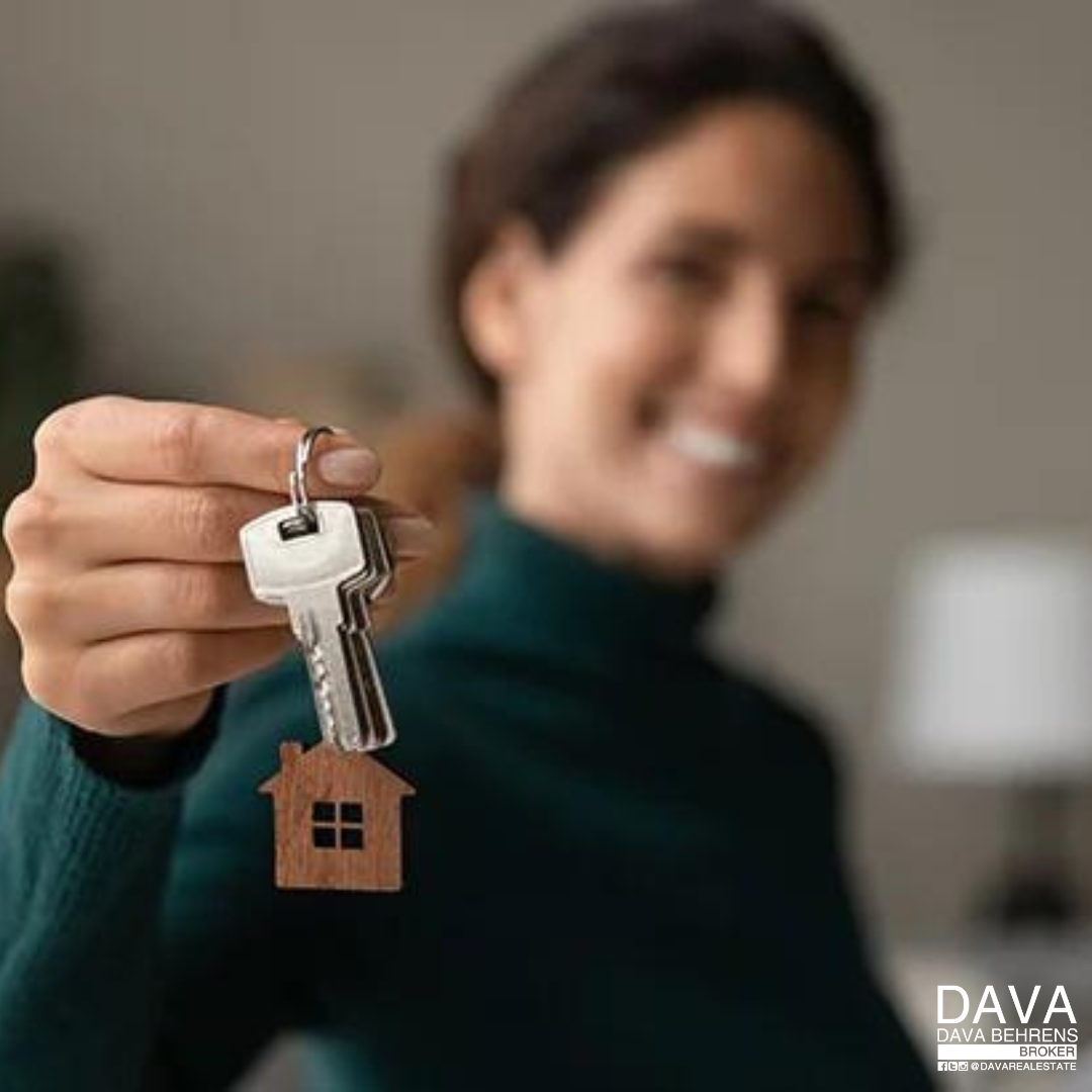 Woman holding house keys, new home.