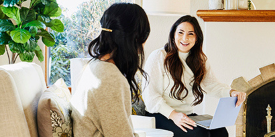 Two women talking, real estate meeting.