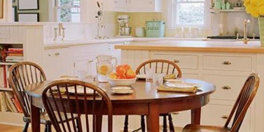 Farmhouse kitchen table with wooden chairs.