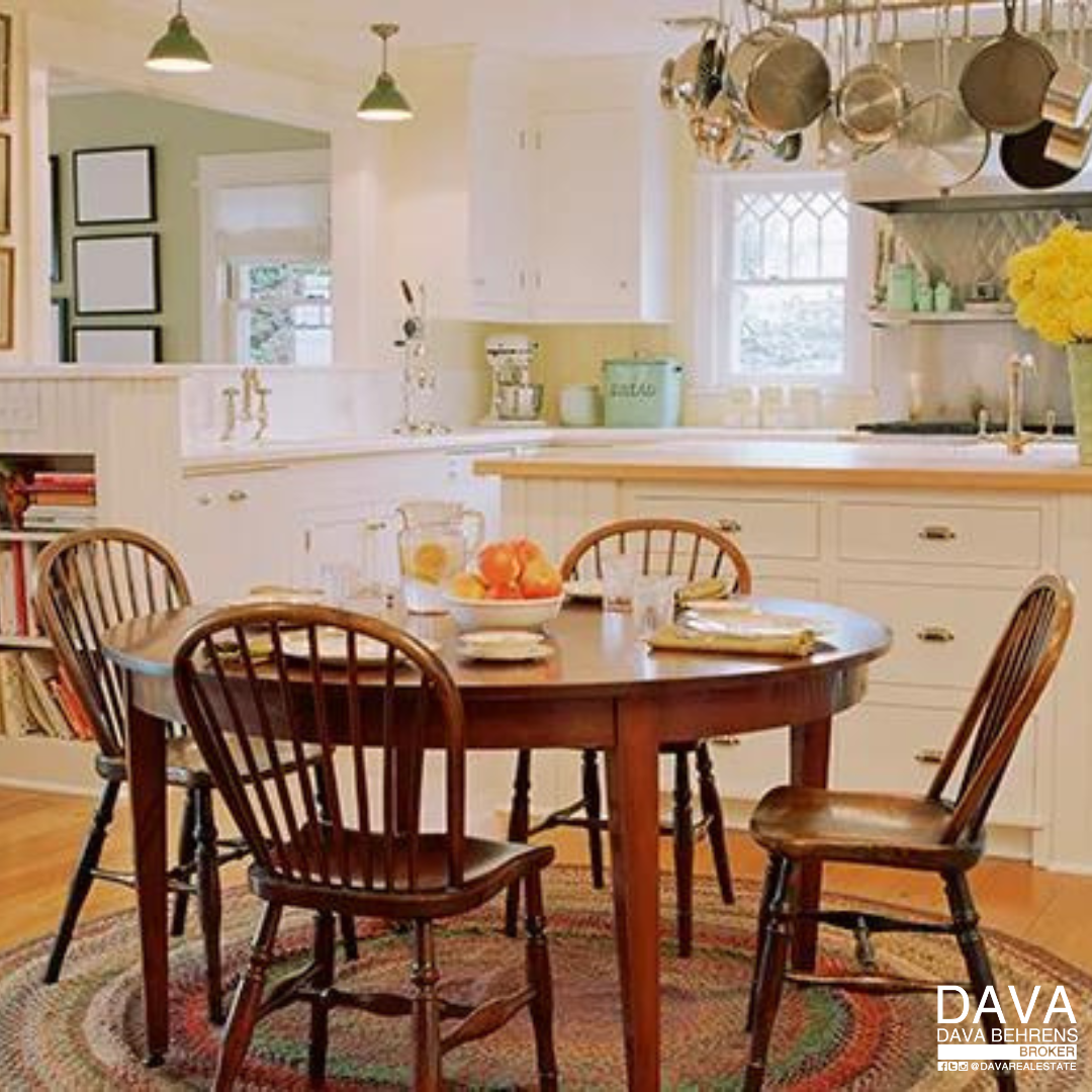 Farmhouse kitchen table with wooden chairs.