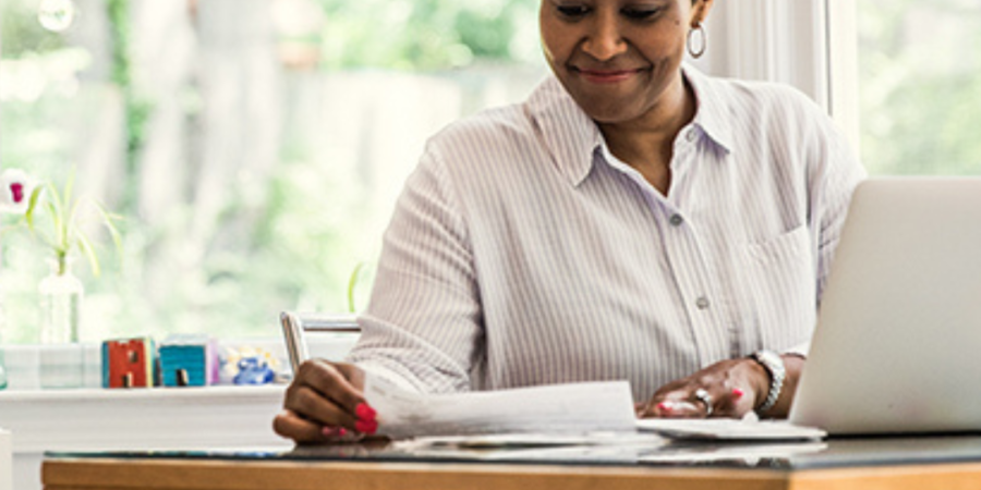 Woman reviewing paperwork at home.