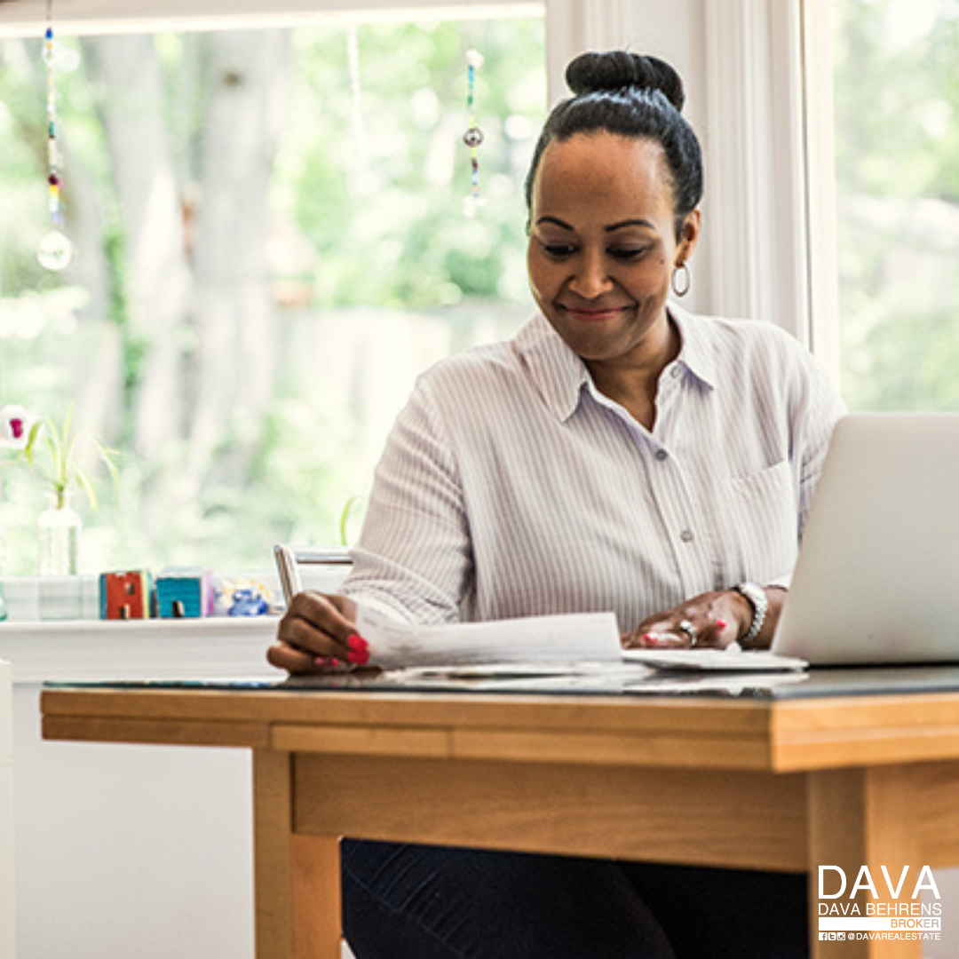 Woman reviewing paperwork at home.