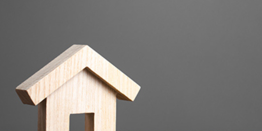 Wooden house model on wood table.