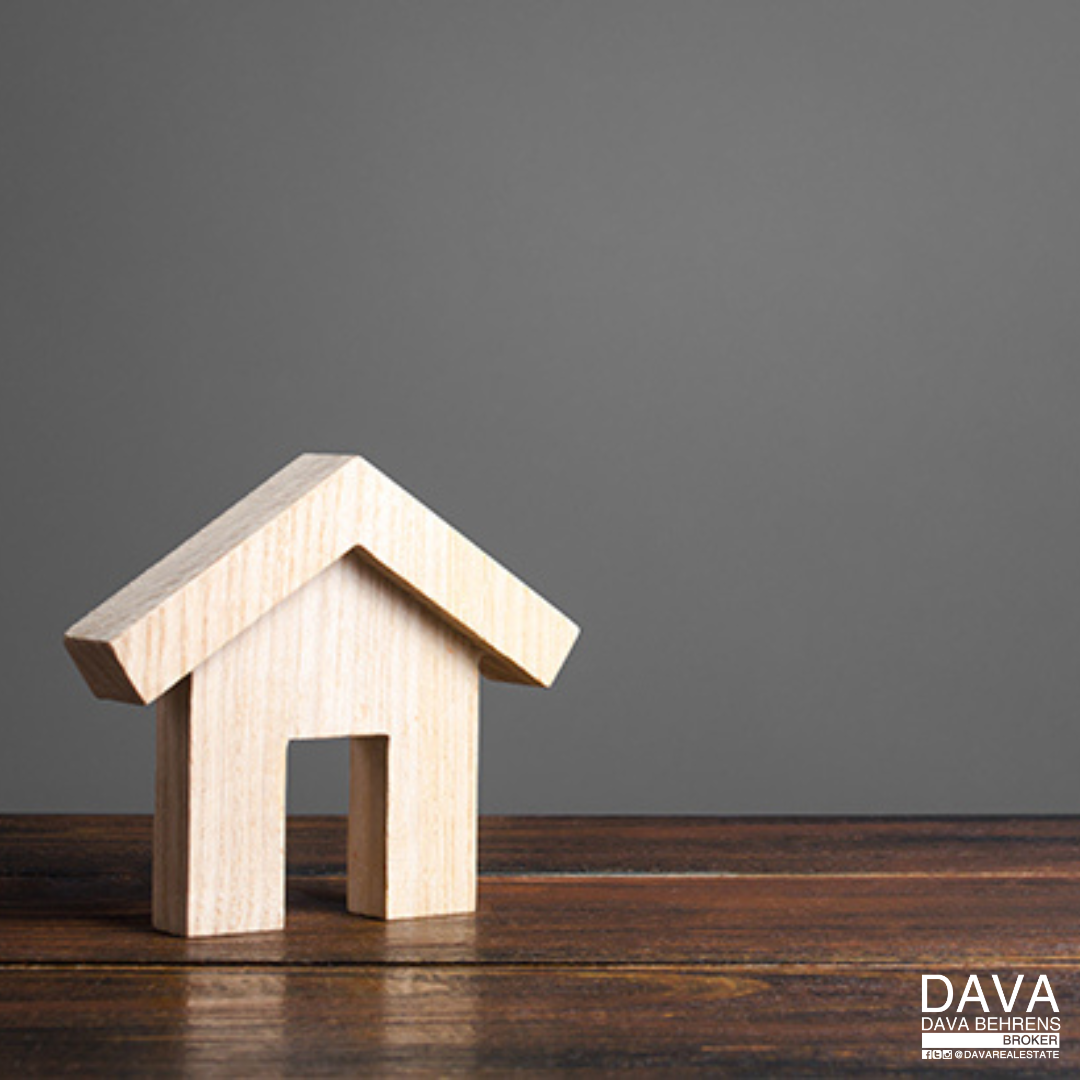 Wooden house model on wood table.