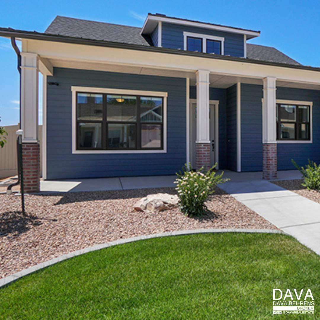 Blue house with porch and landscaping.