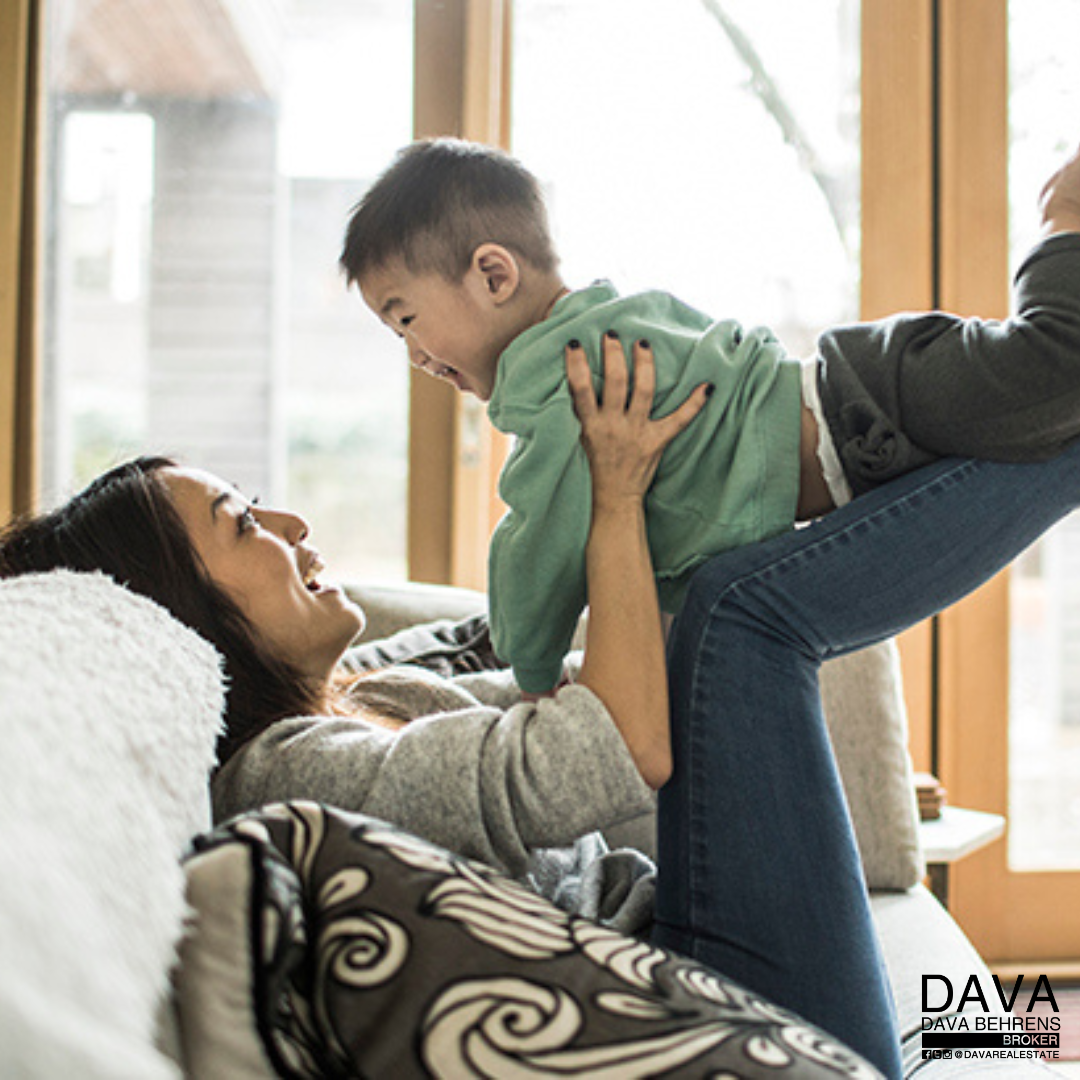 Mom playfully lifts her toddler son.