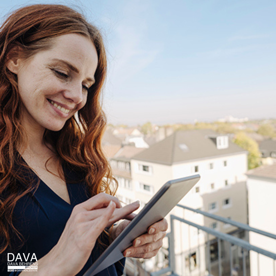 Woman using tablet, city view.