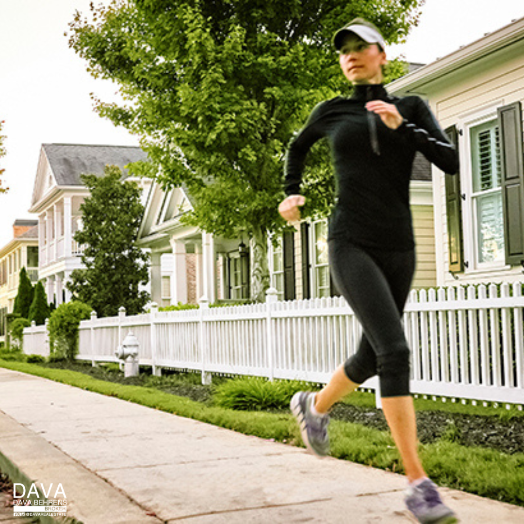 Woman jogging in residential neighborhood.