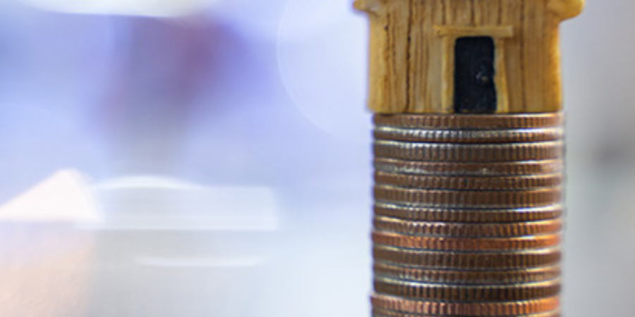 House model on stack of coins.