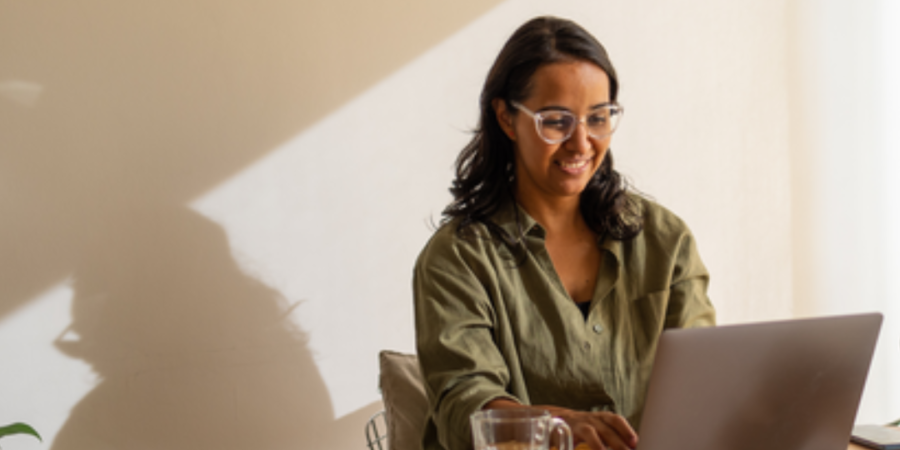 Woman working on laptop at home.