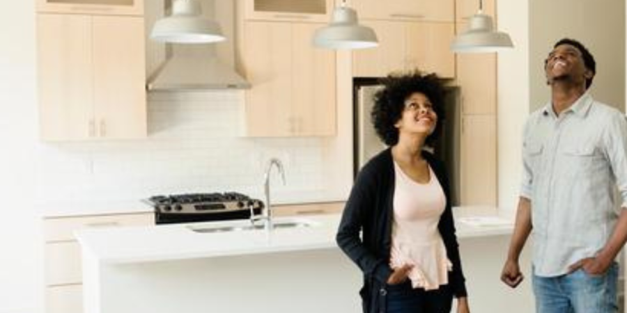 Couple looking up at new kitchen.