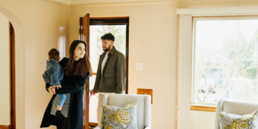 Family entering new home with baby.