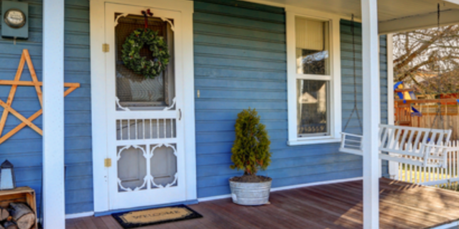 Blue house porch with wooden deck.