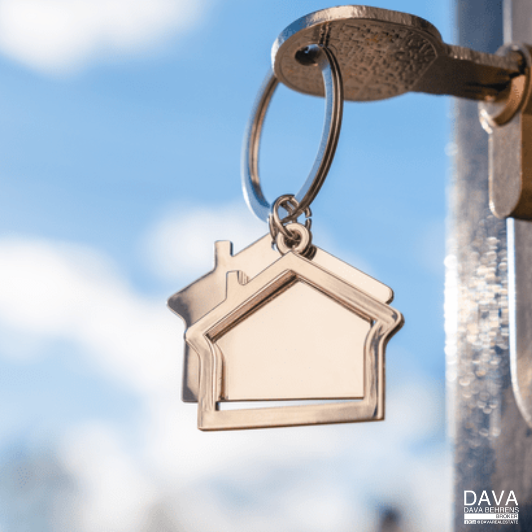 House key on keychain, blue sky.