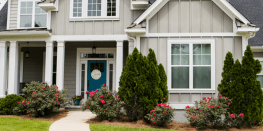 Gray house with teal front door.