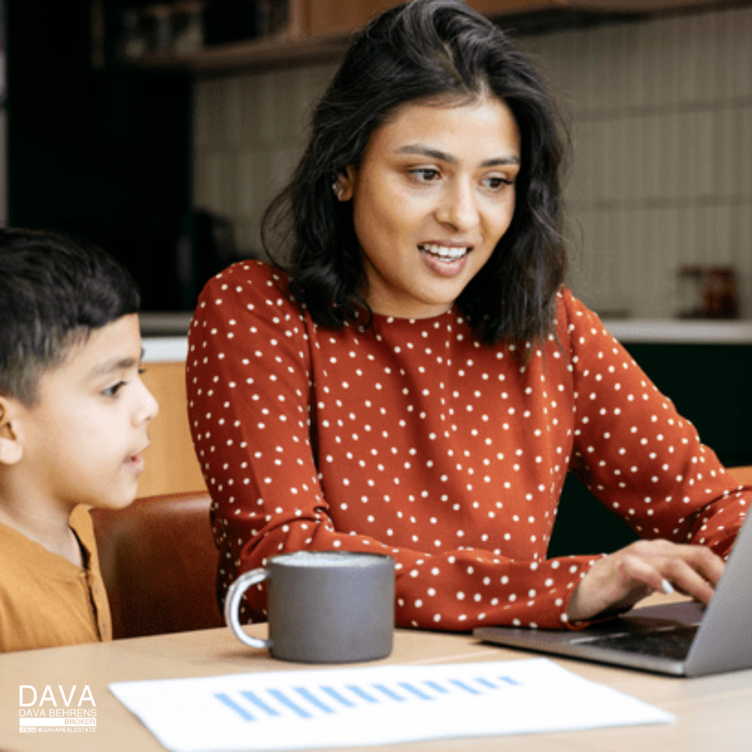 Woman working from home with child.