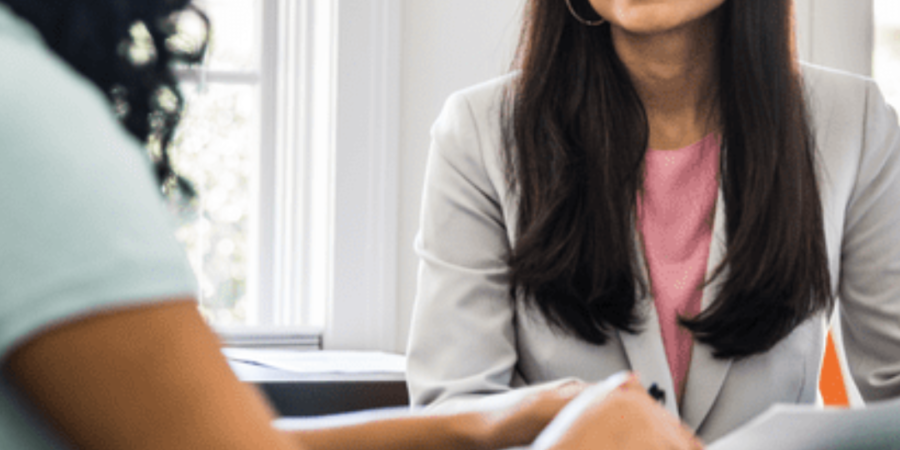 Two women discussing real estate.