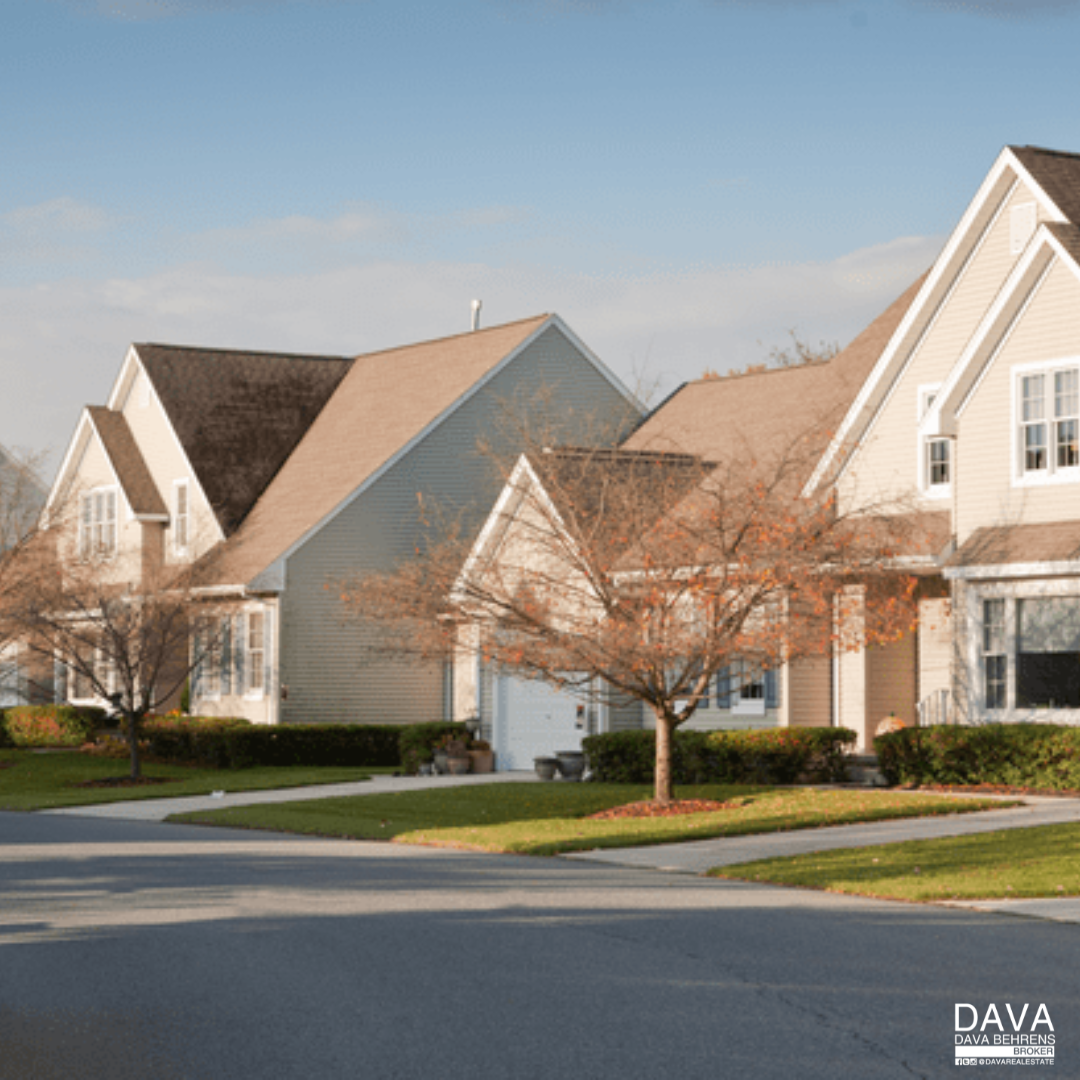 Suburban homes on a tree-lined street.