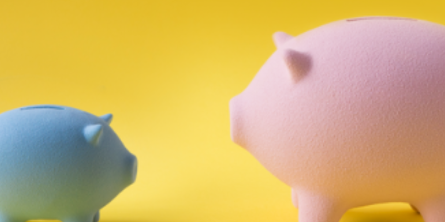 Pink and blue piggy banks saving money.