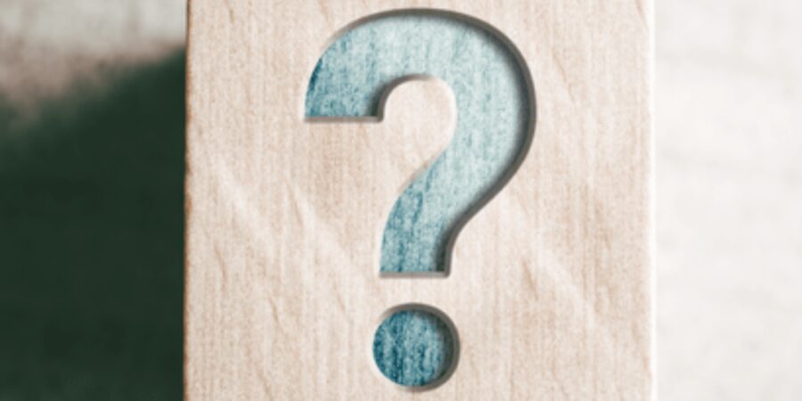 Wooden block with a blue question mark.