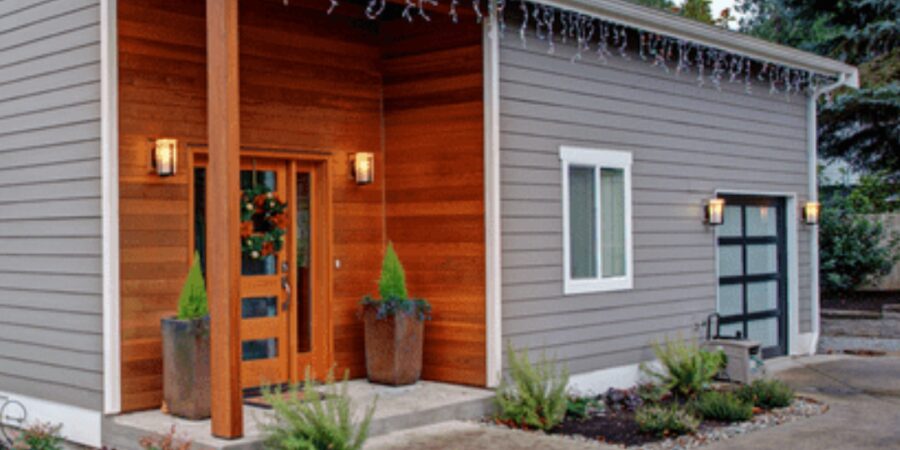 Modern home exterior with decorative plants.