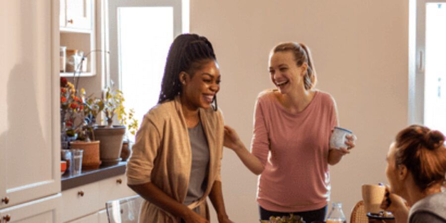 Friends enjoying cooking in a cozy kitchen.