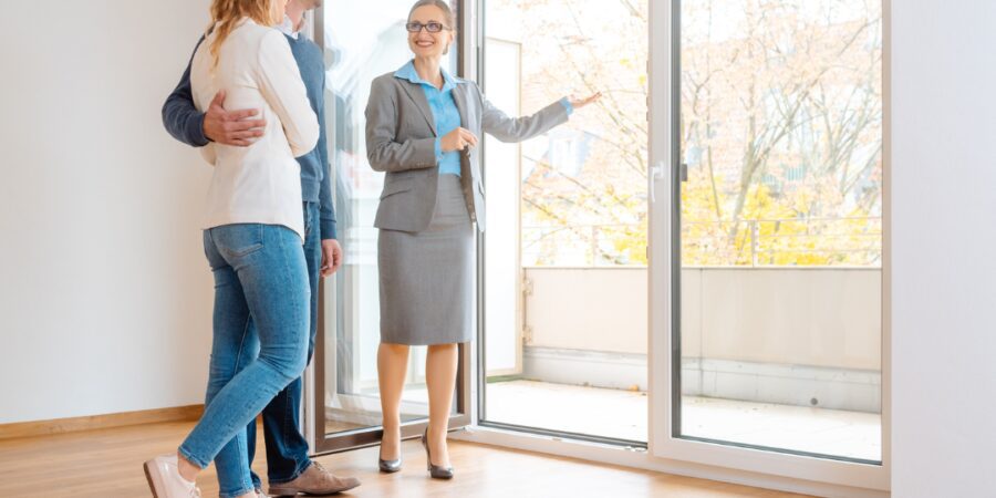 Couple touring a property with an agent.