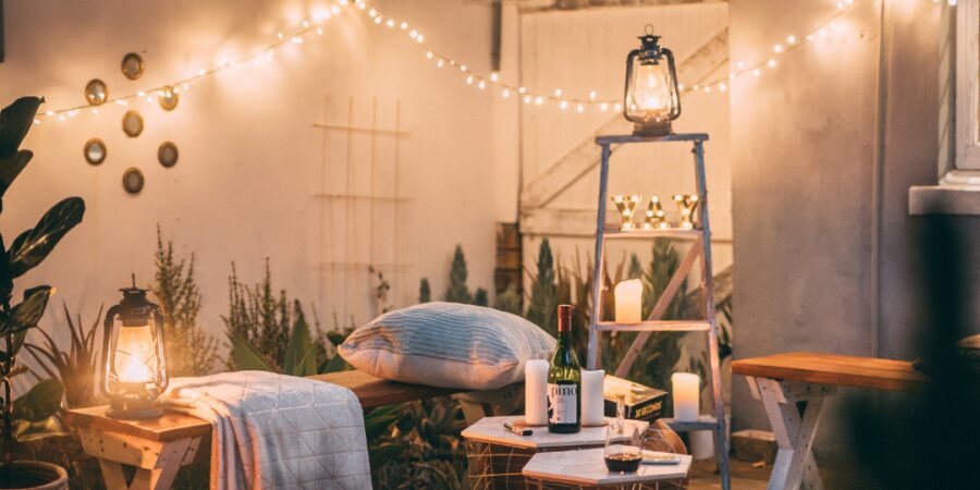 Cozy outdoor seating with lights and decor.