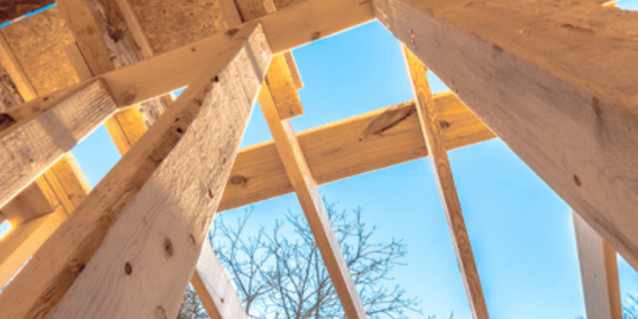 View of wooden beams against blue sky.