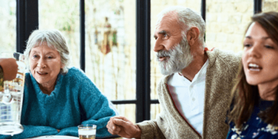 Family gathering around a dinner table.