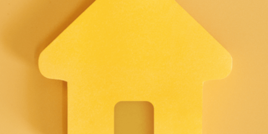 Yellow house silhouette on a yellow background.