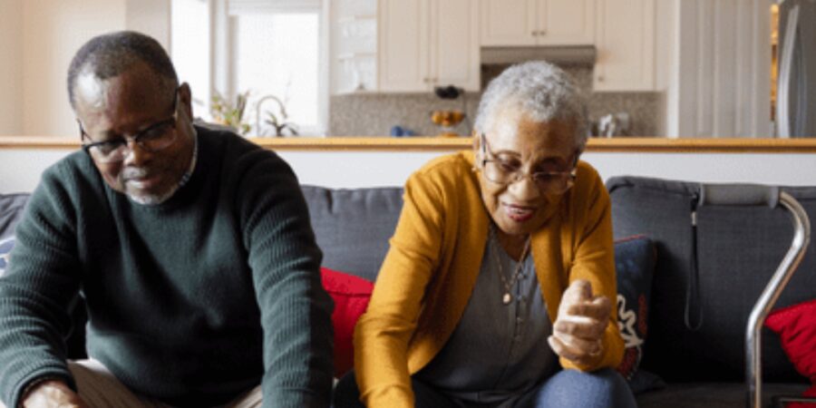 Elderly couple enjoying a puzzle together.