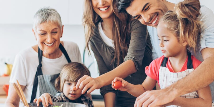 Family preparing food together in kitchen.