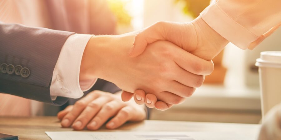 Business handshake over a table.