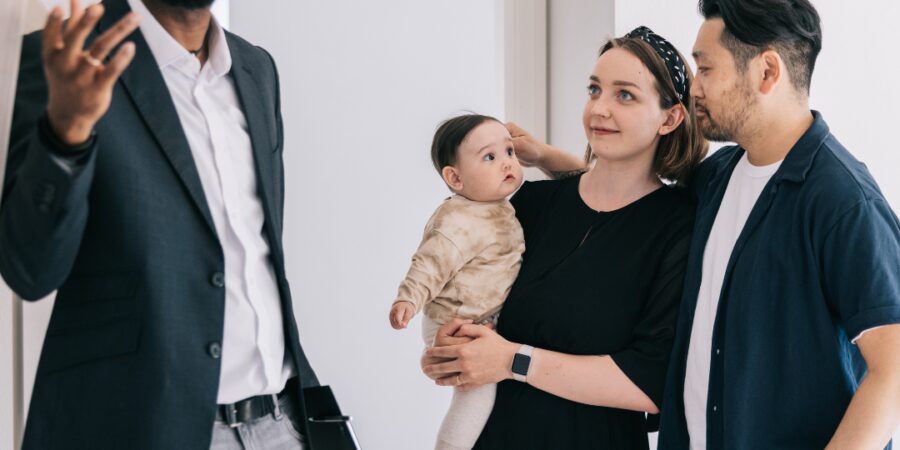 Family with baby listening to a speaker.