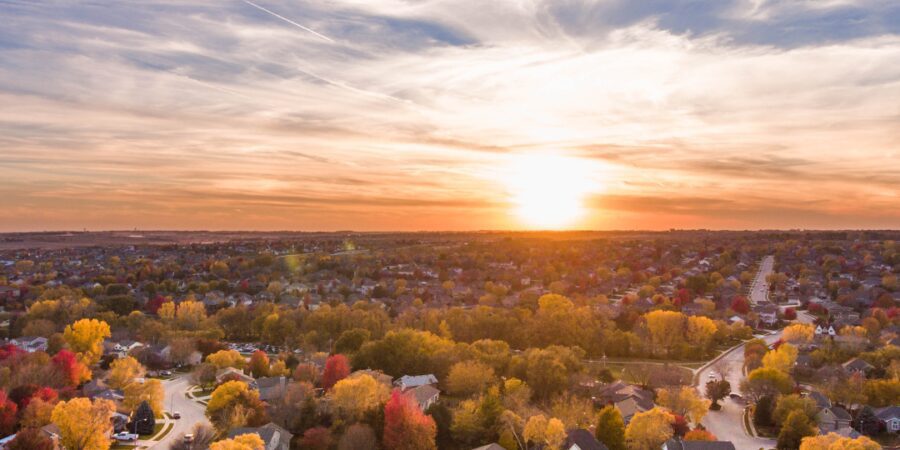Aerial view of colorful autumn neighborhood sunset.