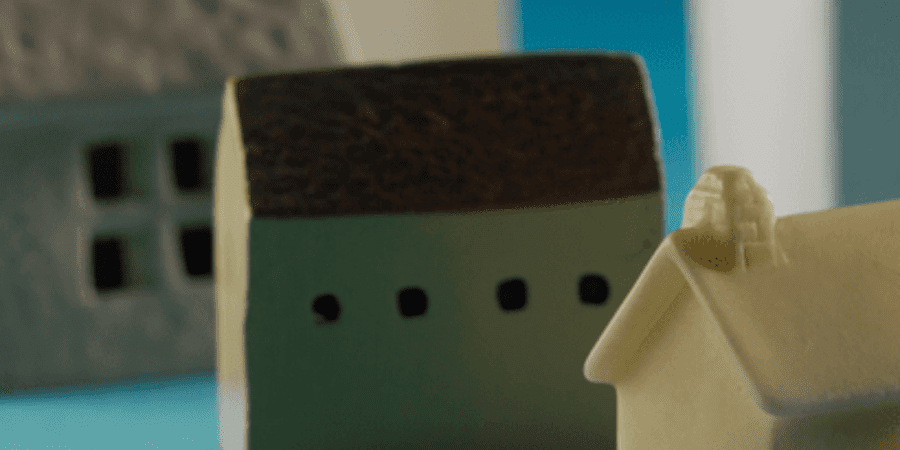 Miniature houses on blue background.