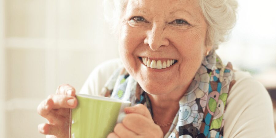 Smiling senior woman enjoying a cup of tea.