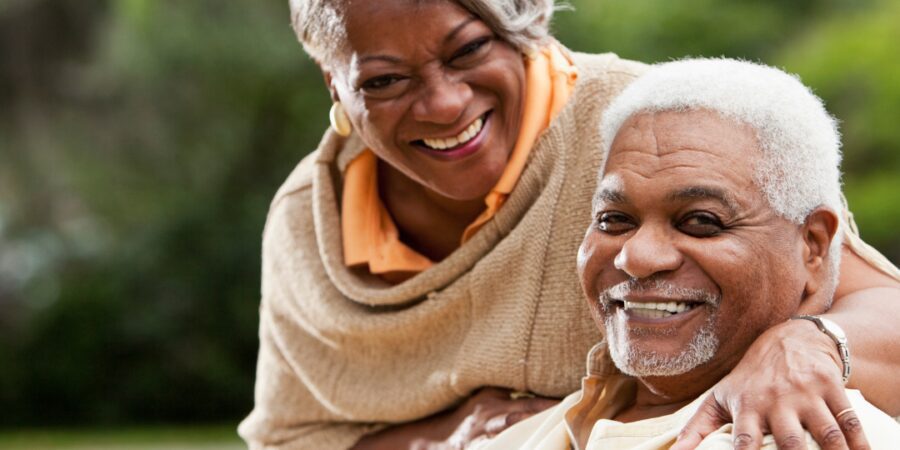 Happy senior couple embracing outdoors.