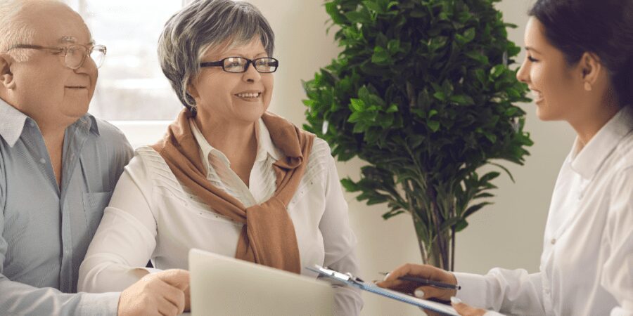 Senior couple consulting with financial advisor.