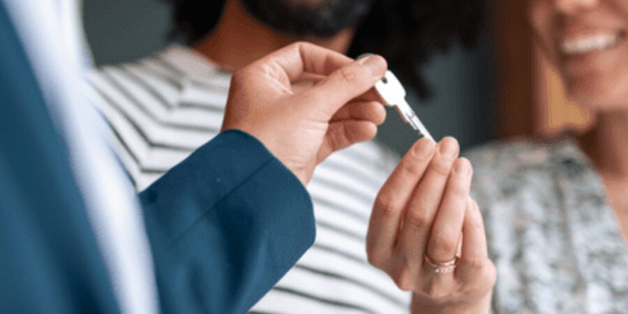 Happy couple receives house keys.