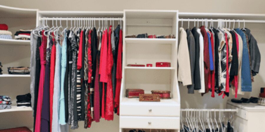 Organized walk-in closet with clothing.