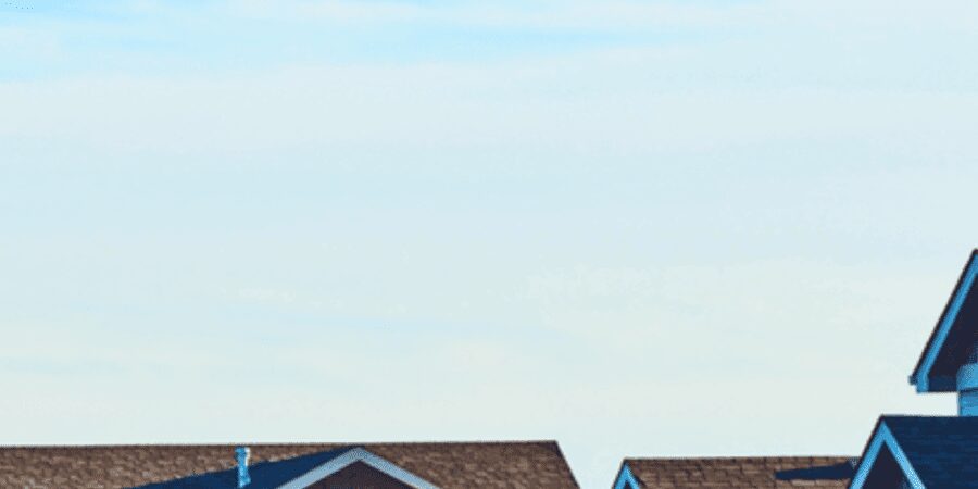 Rooftops against a clear blue sky.
