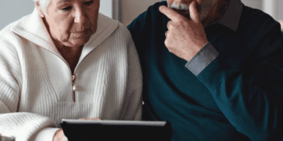 Elderly couple using a tablet together.